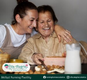 Doña Eli y su nieta con un pastel en Villa Alegría Nursing