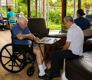Two older adults receiving personalized care and companionship at Villa Alegría Nursing Home in Costa Rica.