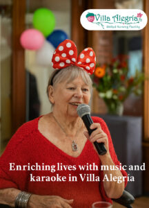 Elderly woman enjoying a joyful karaoke moment with a microphone at Villa Alegría, surrounded by warm colors and festive decorations.