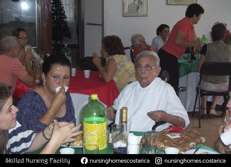 Vibrant gathering at Villa Alegría, residents dining and sharing laughter.