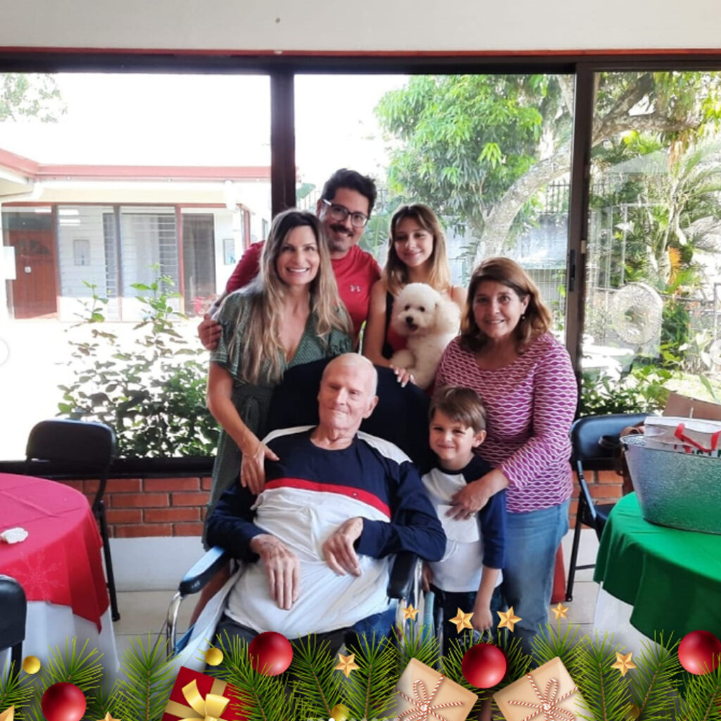 Resident at Villa Alegría Nursing Home enjoying a meaningful family visit in a warm and welcoming environment in Costa Rica.
