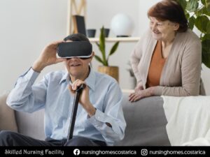 Elderly man wearing virtual reality glasses while his excited wife looks on, showcasing the transformative power of technology in senior living.