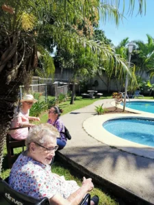 Older adults enjoying a safe and peaceful outdoor environment at Villa Alegría Nursing Home in Costa Rica.