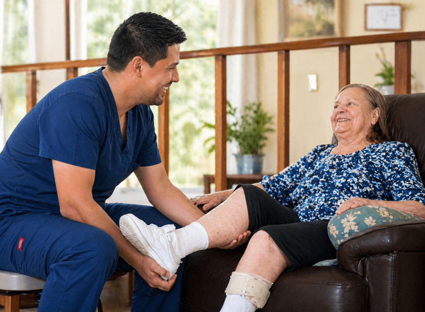 Caregiver assisting an elderly woman with physical therapy exercises at Villa Alegría nursing home in Costa Rica