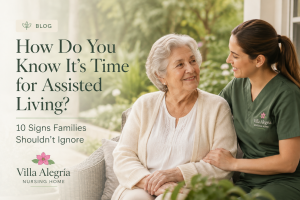 Compassionate caregiver talking with an older woman at Villa Alegría Nursing Home, representing the signs it's time for assisted living.
